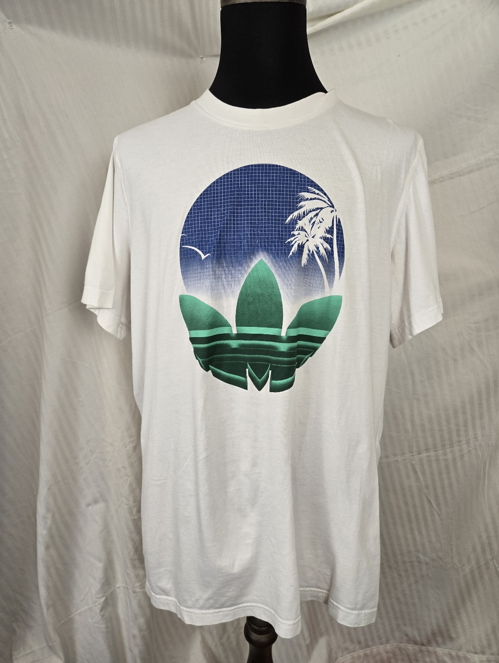 Adidas White Tee with Blue Circular Graphic.   TM